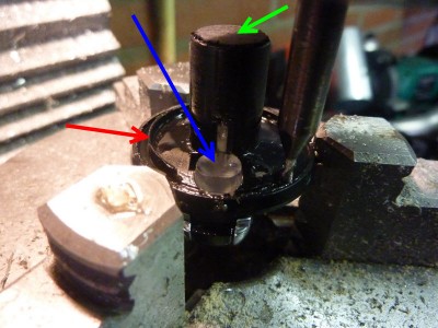 I've remachined the inner diameter to match the old buttons (Red arrow). Then machined the lens so that it wouldn't touch the led-ring in the unit (Blue arrow). And pressed in a piece of wood, (round 11mm.) for mounting the Set screw (Green arrow)